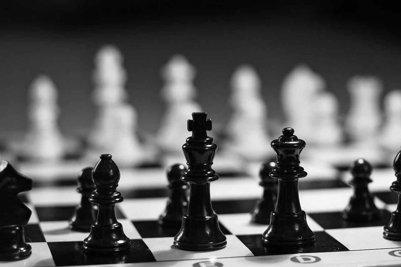 A sleek, minimalist, abstract client logo rendered in a metallic or glowing cyber-style.